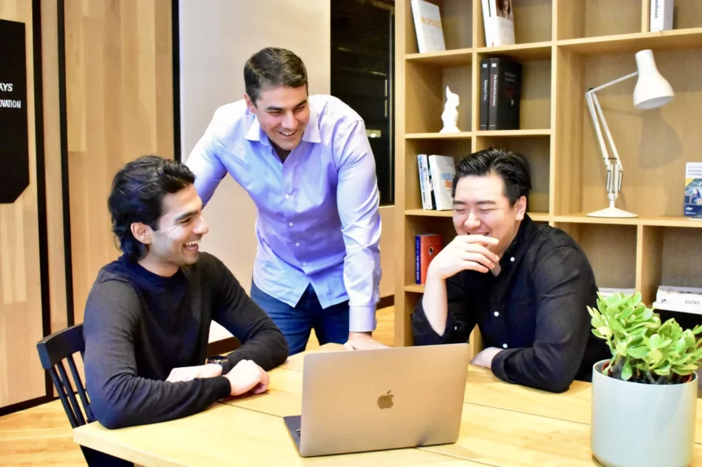Group of guys around a laptop